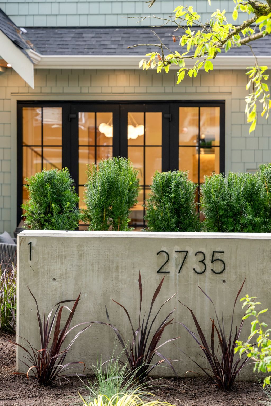 The Eton — bi-folding glass doors at dusk